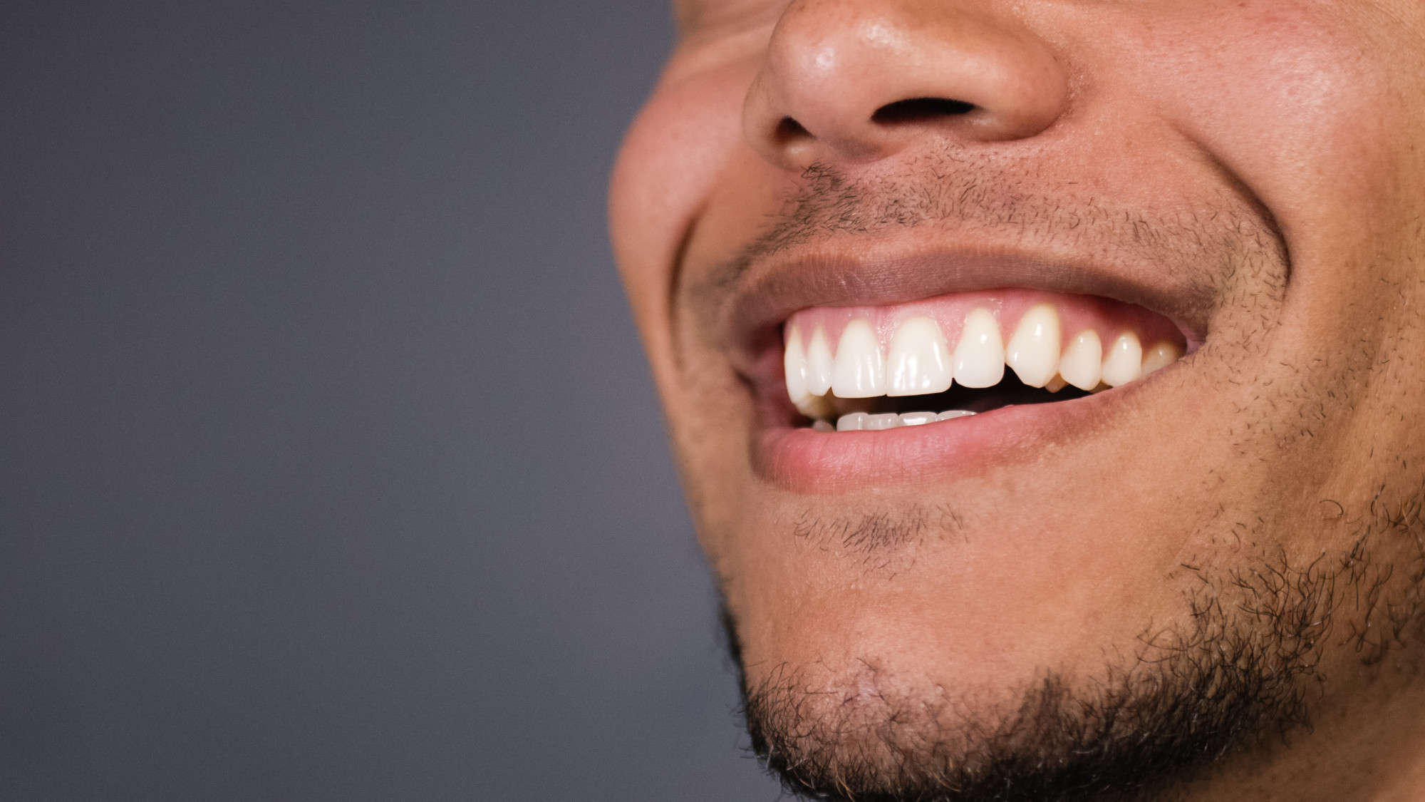 man smiling with cosmetically pleasing teeth