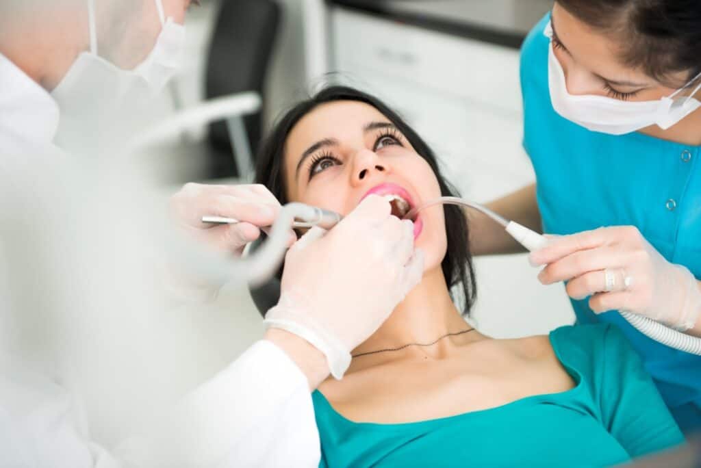 A woman receiving dental restoration in a dental chair