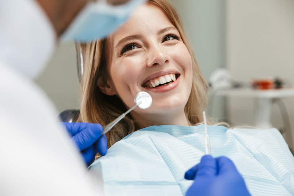 woman receiving dental fillings while sitting in dental chair