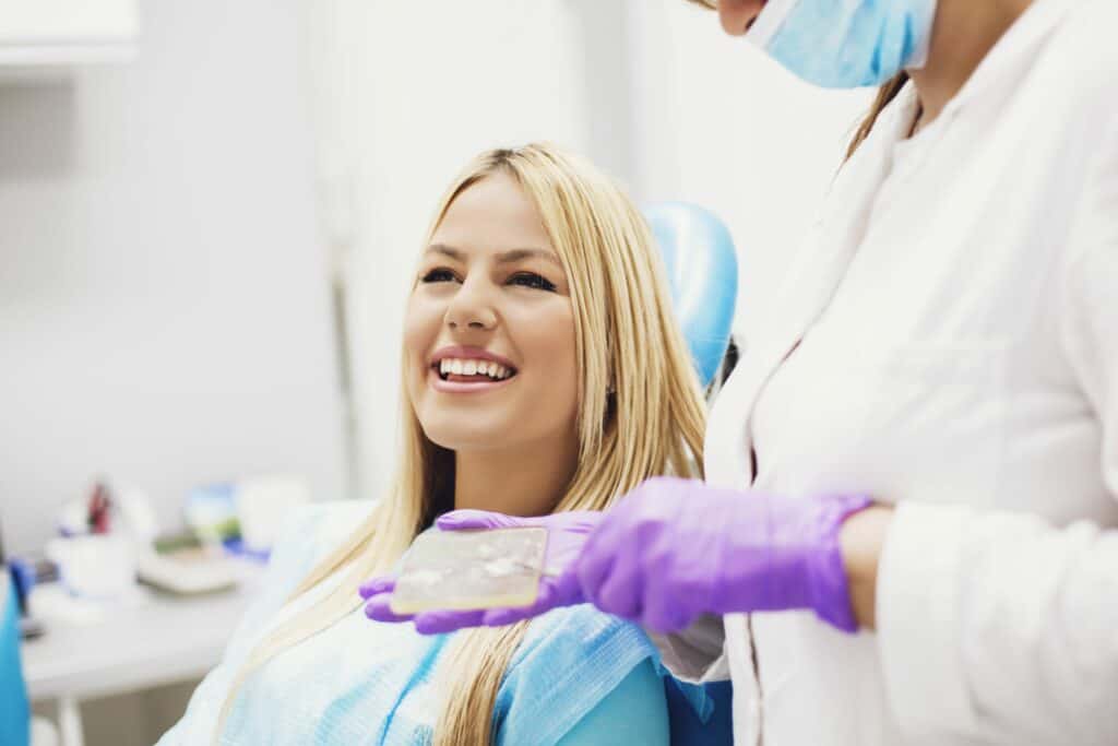 women in dental chair smiling