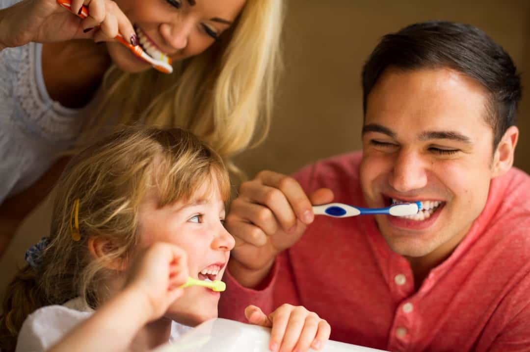 Family with good oral health brushing teeth