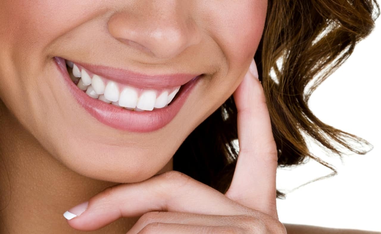 Woman has perfect white teeth after teeth whitening procedure in Washington, DC