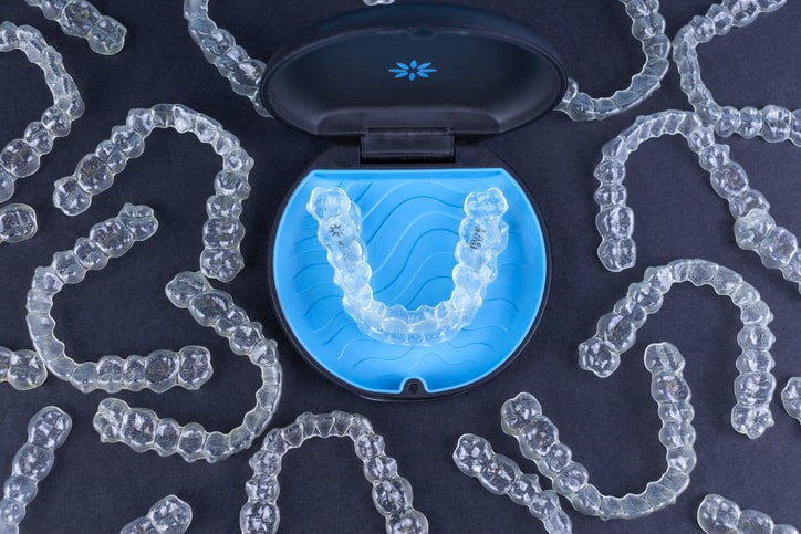 Invisalign Aligners and case on black background