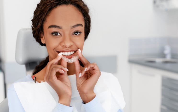 Woman with professional teeth whitening tray